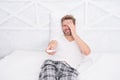 Nice comedy show. man watch tv. change channel by remote control in bed. happy man in pajama with remote control. guy Royalty Free Stock Photo