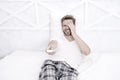 nice comedy show. man watch tv. change channel by remote control in bed. happy man in pajama with remote control. guy Royalty Free Stock Photo