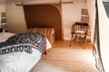 nice comfortable room in a tent with big wicker trunk and old wooden table with two rolled towels on it