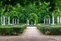 Nice corner of public park with old white stone columns and seating for lounging. Aranjuez Royalty Free Stock Photo