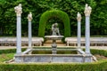 Nice corner of public park with old white stone columns and seating for lounging. Aranjuez