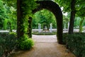 Nice corner of public park with old white stone columns and seating for lounging. Aranjuez