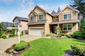 Nice curb appeal of American two story house with perfect landscape design.