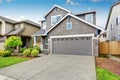 Nice curb appeal of two level house, mocha exterior paint and concrete driveway Royalty Free Stock Photo