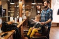 Nice cute boy visiting a barbershop