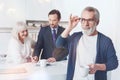 Positive elderly man meeting with insurance agent at home Royalty Free Stock Photo