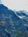 Nice day for hiking. Beautiful view from the mountain range to the snow-capped mountains and clouds. Sunny day for travel - Royalty Free Stock Photo