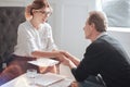 Nice delighted man holding the hand of his psychologist Royalty Free Stock Photo