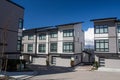 Nice development of new townhouses. External facade of a row of colorful modern urban townhouses.brand new houses just after const Royalty Free Stock Photo