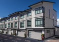 Nice development of new townhouses. External facade of a row of colorful modern urban townhouses.brand new houses just after const Royalty Free Stock Photo