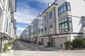 Nice development of new townhouses. External facade of a row of colorful modern urban townhouses.brand new houses just after const Royalty Free Stock Photo