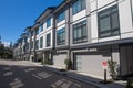 Nice development of new townhouses. Rows of townhomes side by side. External facade of a row of colorful modern urban townhouses. Royalty Free Stock Photo