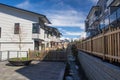 Nice development of new townhouses. Rows of townhomes side by side. External facade of a row of colorful modern urban townhouses. Royalty Free Stock Photo