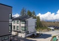 Nice development of new townhouses. Rows of townhomes side by side. External facade of a row of colorful modern urban townhouses. Royalty Free Stock Photo