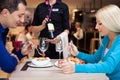 Nice dinner in a restaurant - waiter offers wine