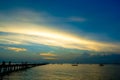 Nice dramatic sky at sea with silhouette of jetty