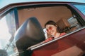 Girl wearing sunglasses sitting behind the wheel in the driver& x27;s seat Royalty Free Stock Photo