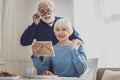 Nice elderly couple looking at the family photo