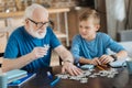 Nice elderly man holding a puzzle piece Royalty Free Stock Photo