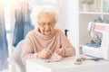 Nice elderly woman sewing Royalty Free Stock Photo