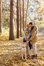 nice family with child son in warm coats enjoy being together, walking with pet Royalty Free Stock Photo