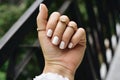 Nice Female Hand with Manicured White Nails for Wedding Day. Jewelry Rings