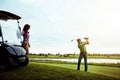 Nice form, babe. a man practicing his swing on the golf course. Royalty Free Stock Photo