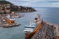 Nice, France. Aerial view of the old port of Nice, big cruise liners, lighthouse, parked cars at the dock and city on the hill. Royalty Free Stock Photo