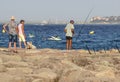 Nice , France - 5 august 2017 :Man fishing on a breakwater with boats in the background in France -