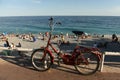 Nice, France - June 19, 2019: Bicycle on the promenade of Nice and people on the beach of the Nice