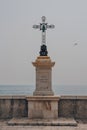Crucifix monument with inscription In Memoriam Jubilaei 1829 et Pacis 1871 on the Promenade des Anglais in Nice, France