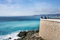 Nice, France, March 2019. Panorama. Azure sea, waves, English promenade and people resting. Rest and relaxation by the sea. On a