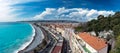 Panorama. Azure sea, waves, English promenade and people resting. Rest and relaxation by the sea.