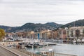 NICE, FRANCE - 17 SEPTEMBER 2017: harbour of old european city located on seashore with hills on background Royalty Free Stock Photo