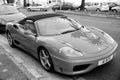 Red sports car ferrari convertible parking on road in France