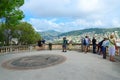 Tourists on observation deck in park on Roman hill parc de la Colline du Chateau admire beautiful view of Nice, Fra