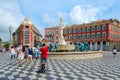 Tourists are near fountain Sun Fontaine du Soleil on Place Massena, Nice, France Royalty Free Stock Photo