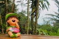 Nice funny welcome figure in asian tropical garden Royalty Free Stock Photo