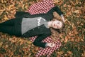 The girl is lying on the ground in the leaves Royalty Free Stock Photo