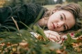 The girl lies on the ground in the leaves and looks at the camera Royalty Free Stock Photo