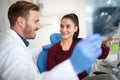 Girl with dentist in clinic take care of her teeth