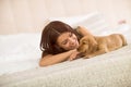 Girl and her puppy pet enjoy in bed Royalty Free Stock Photo