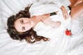 Girl in lingerie lying on a bed with a rose Royalty Free Stock Photo