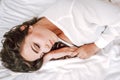 Girl in lingerie lying on a bed with a rose Royalty Free Stock Photo