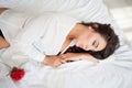 Girl in lingerie lying on a bed with a rose Royalty Free Stock Photo