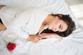 Girl in lingerie lying on a bed with a rose Royalty Free Stock Photo