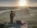 Nice girl photographer in cowboy cap photographing on  camera Royalty Free Stock Photo