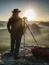 Nice girl photographer in cowboy cap photographing on  camera Royalty Free Stock Photo