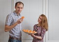 Nice girl with sandwiches treats the young man