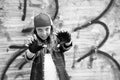 Nice girl, teenager, in a baseball cap extended her arms forward, against the background of a vintage wall. Black and white photo Royalty Free Stock Photo